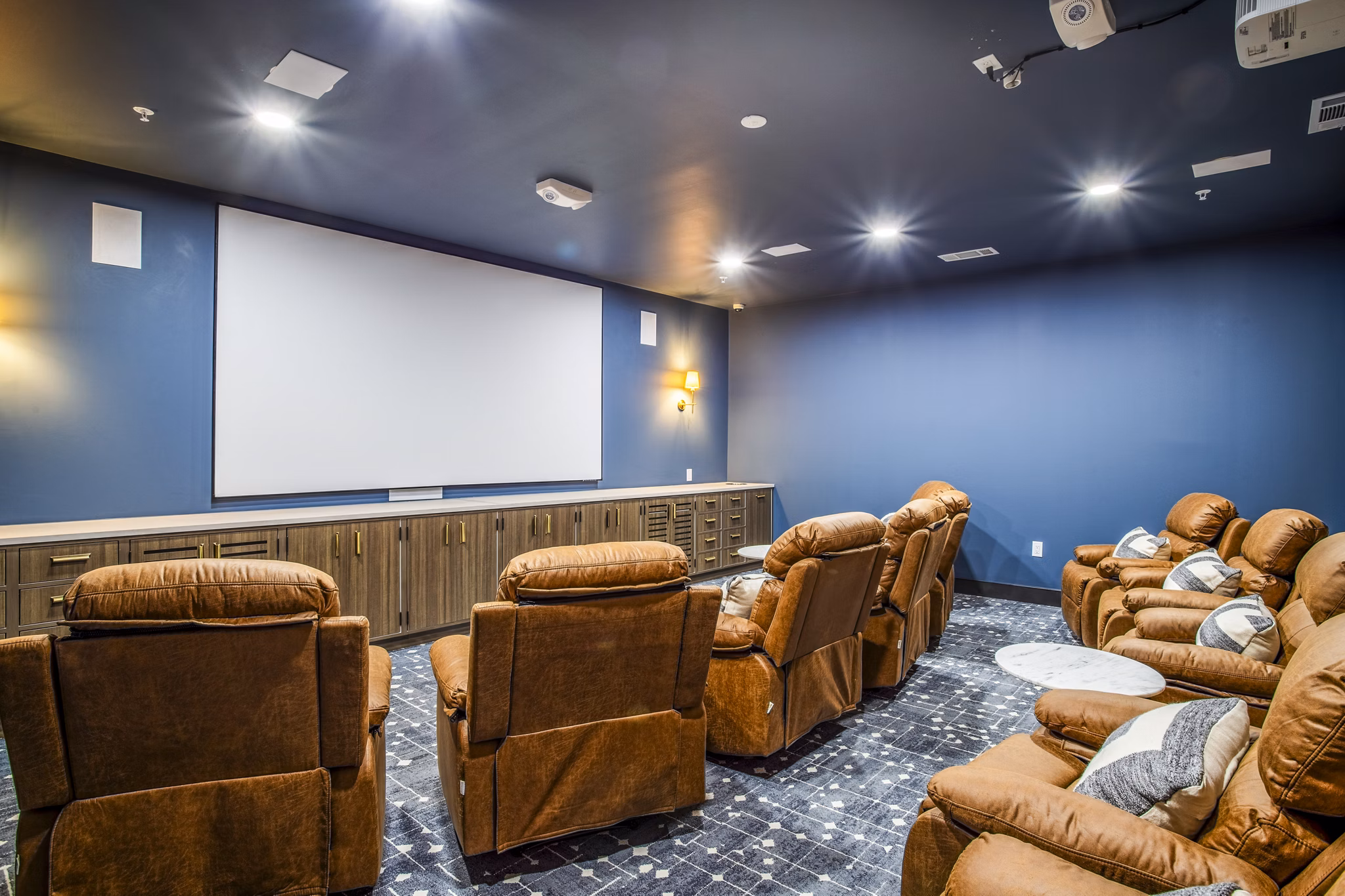 Clubhouse theater with plush seating at West End Apartments, luxury living by Greystar