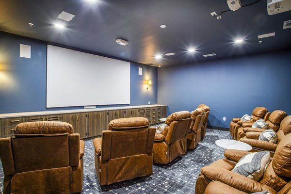Clubhouse theater with plush seating at West End Apartments, luxury living by Greystar