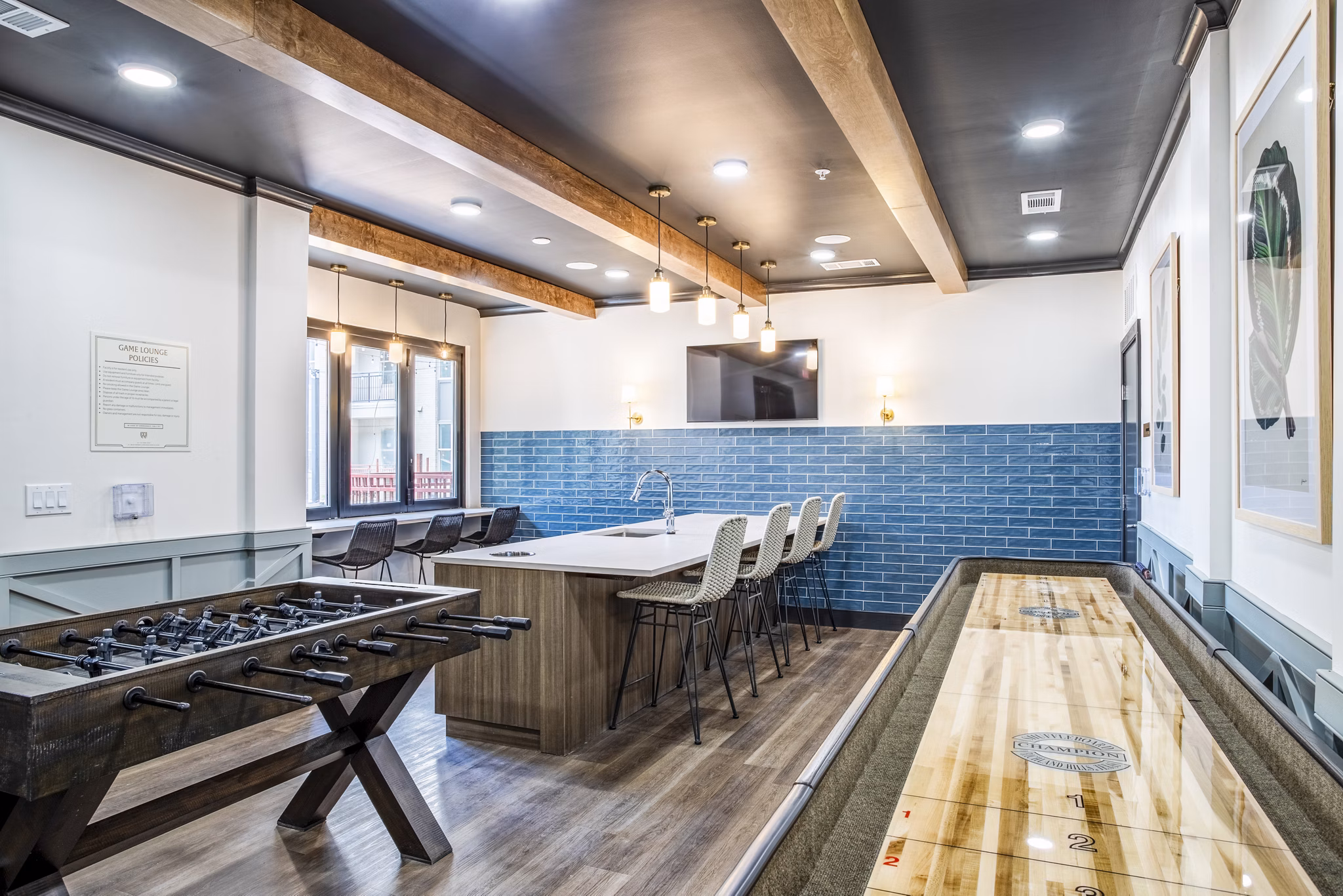 Clubhouse game room with pool table and flat-screen TV at West End Apartments: Luxury leisure space in Greystar's vibrant community