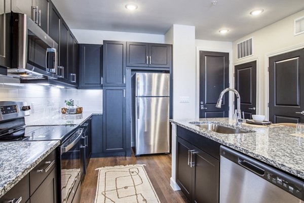 Modern kitchen with stainless steel appliances at West End Apartments, offering luxury living in the heart of the city