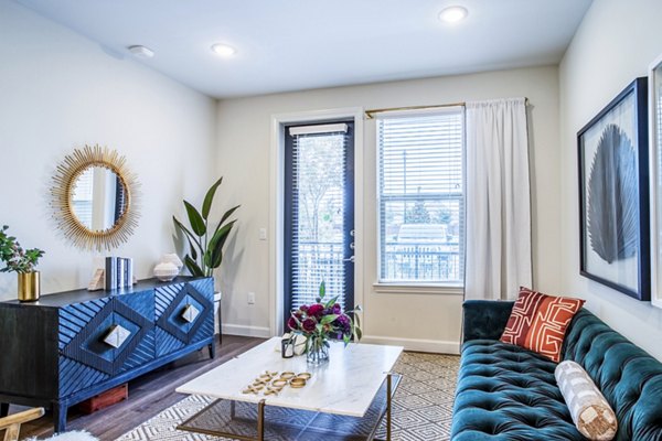 Cozy living room with modern furnishings in West End Apartments, ideal for relaxation and entertaining guests
