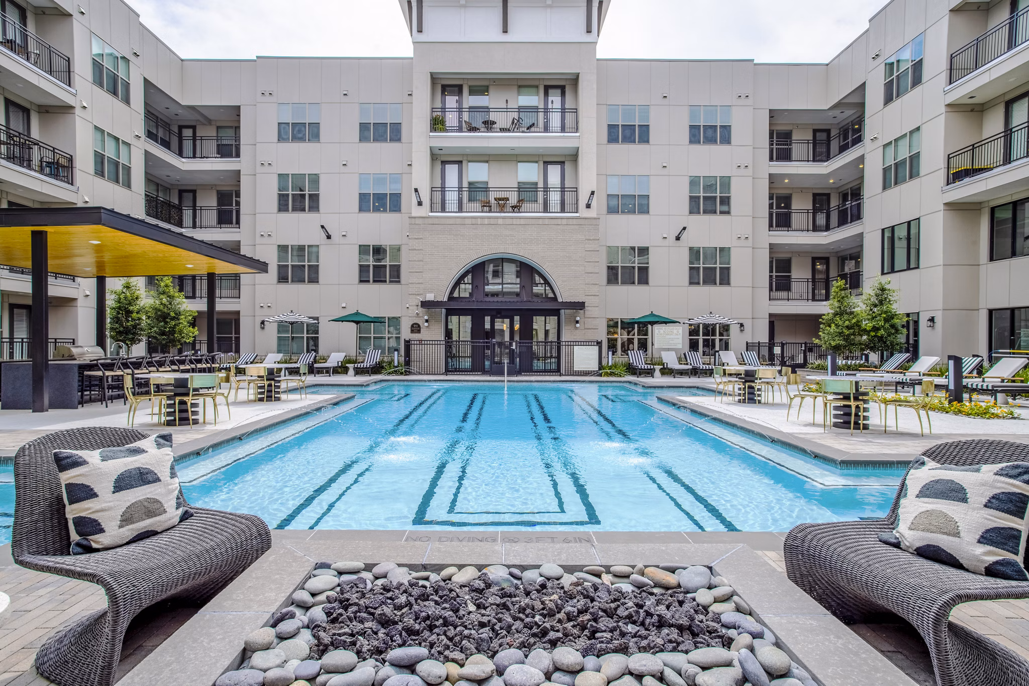Relaxing poolside area at West End Apartments featuring luxurious Greystar amenities for ultimate comfort and leisure