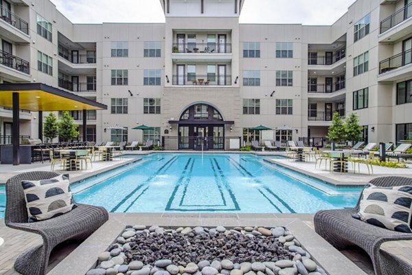 Relaxing poolside area at West End Apartments featuring luxurious Greystar amenities for ultimate comfort and leisure