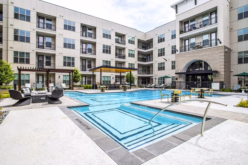Resort-style pool at West End Apartments with comfortable lounge areas and lush landscaping, perfect for relaxation and leisure activities
