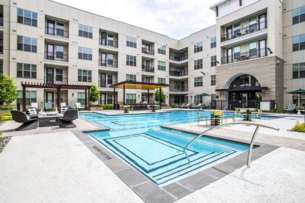 Resort-style pool at West End Apartments with comfortable lounge areas and lush landscaping, perfect for relaxation and leisure activities