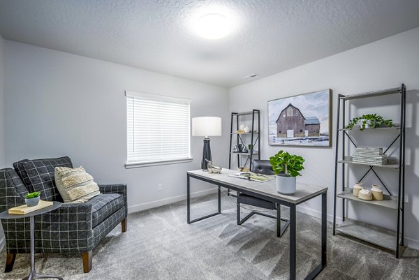 Home office with ergonomic chair and large desk in The Orchard Apartments luxury complex