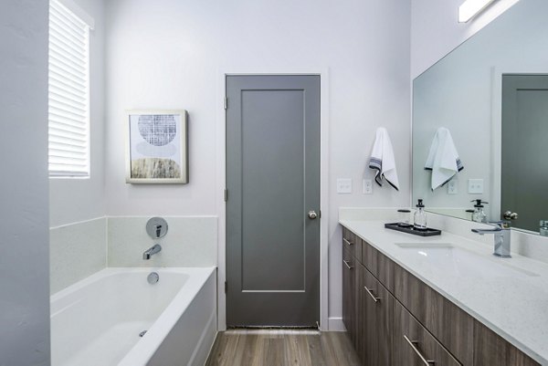Modern bathroom with marble countertops and sleek fixtures at The Orchard Townhomes