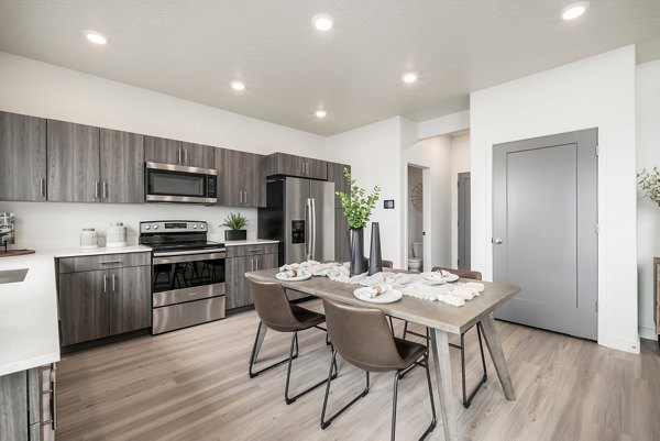 Dining area with modern furnishings and ambient lighting at The Orchard Townhomes