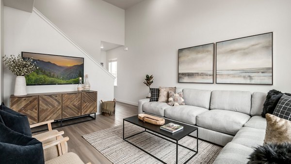 Spacious living room with modern decor in The Orchard Townhomes, featuring luxury apartments by Greystar