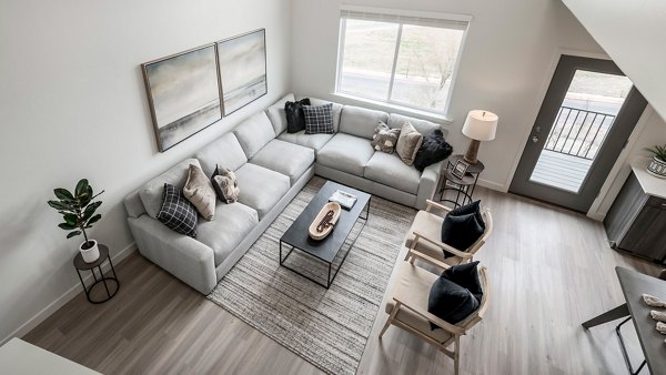 Modern living room with sleek furnishings and hardwood floors in The Orchard Townhomes