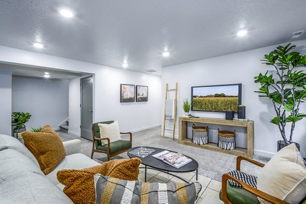 Living room with modern furnishings and bright decor in The Orchard Townhomes, luxury apartments