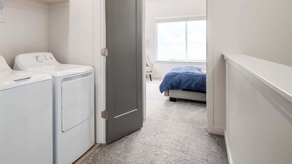 Laundry room with modern appliances at The Orchard Townhomes