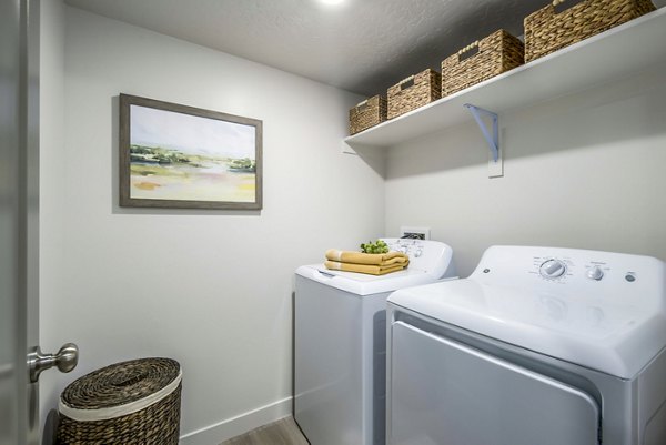 Laundry room with modern appliances at The Orchard Townhomes