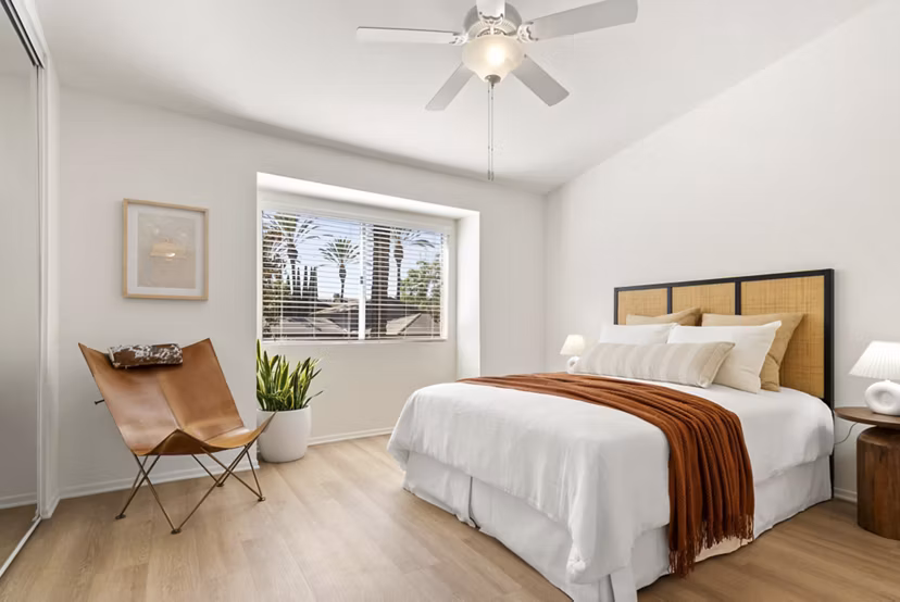 Bedroom with cozy queen bed and modern decor at St Moritz Apartments