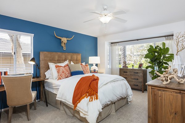 Bedroom with cozy queen bed and modern decor at St Moritz Apartments