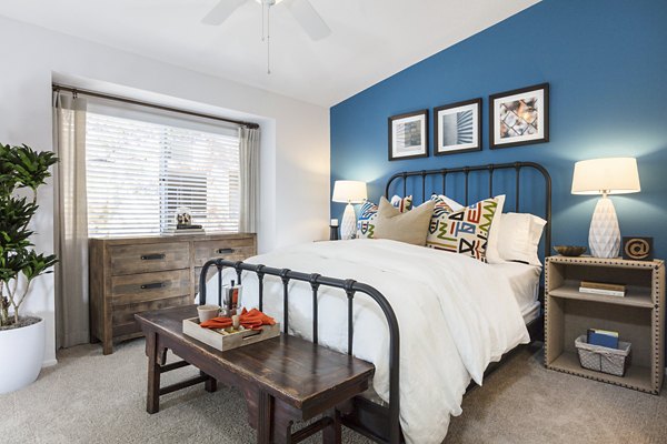 Cozy bedroom with stylish decor at St Moritz Apartments