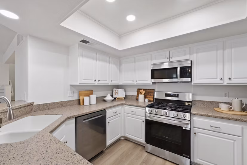 Modern kitchen with stainless steel appliances at St Moritz Apartments, a luxury living space by Greystar