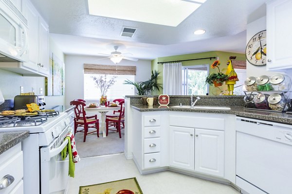 Spacious kitchen with island and stainless steel appliances at St Moritz Apartments