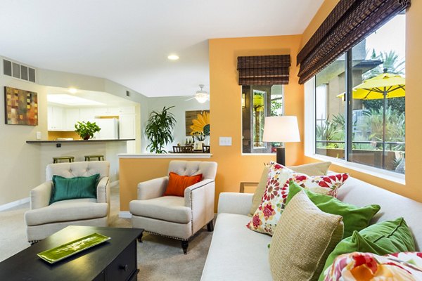 Living room featuring modern furnishings and ample natural light at St Moritz Apartments