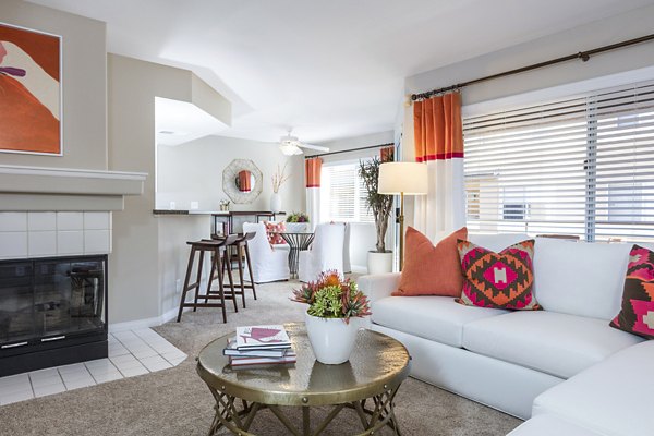 Living area with contemporary furniture and large windows at St Moritz Apartments