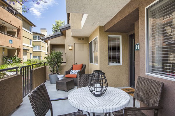 Patio with outdoor seating and lush views at St Moritz Apartments