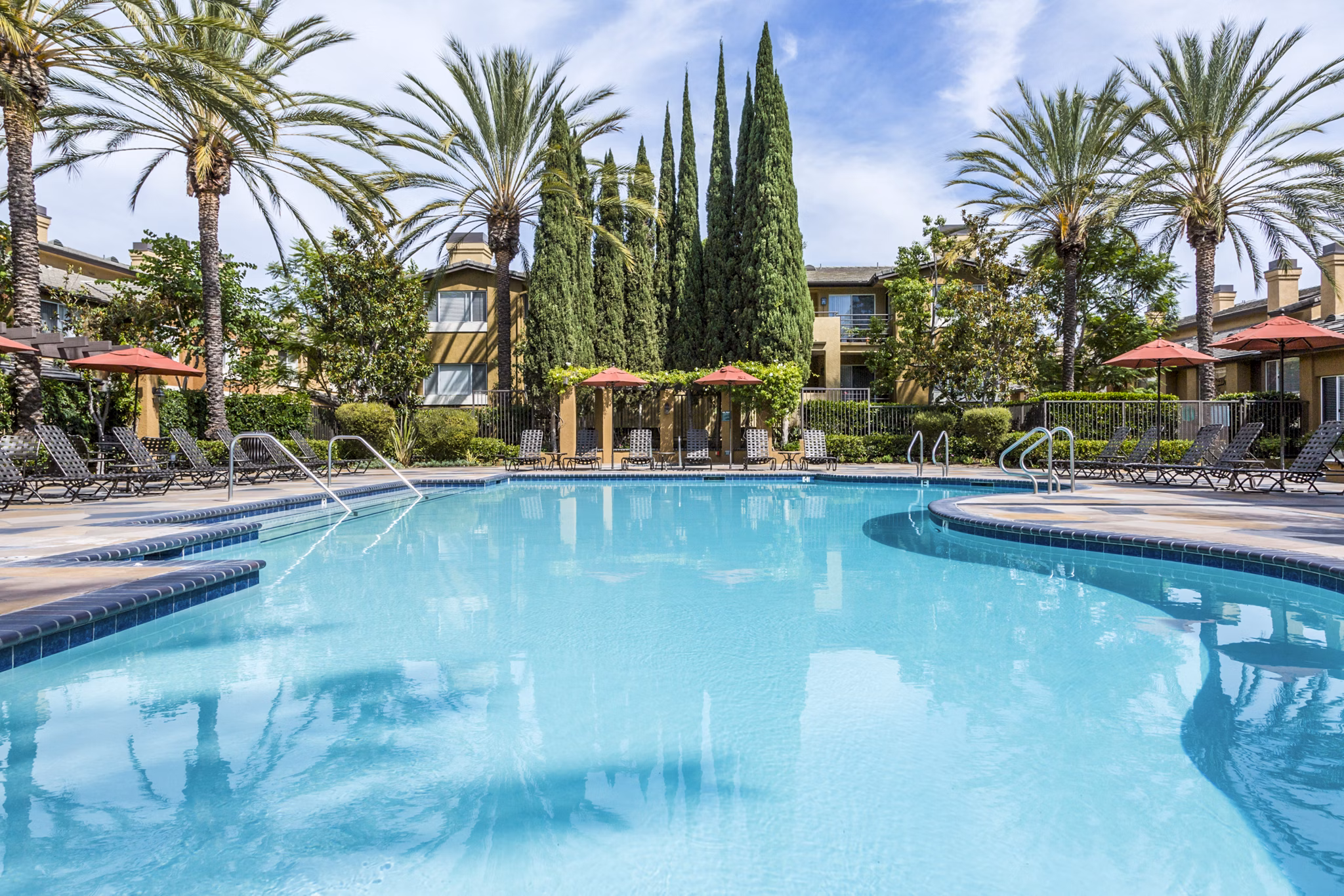 Tranquil pool with surrounding lounge chairs at St Moritz Apartments, ideal for relaxation and leisure activities