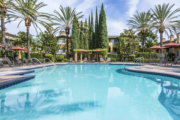 Tranquil pool with surrounding lounge chairs at St Moritz Apartments, ideal for relaxation and leisure activities