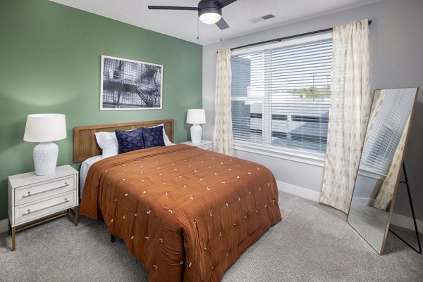 Modern bedroom with large windows at Broadstone Optimist Park Apartments