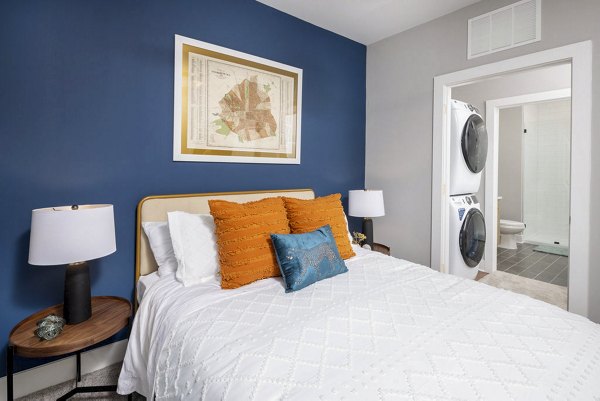 Cozy bedroom with modern decor at Broadstone Optimist Park Apartments, showcasing luxury living in an elegant setting