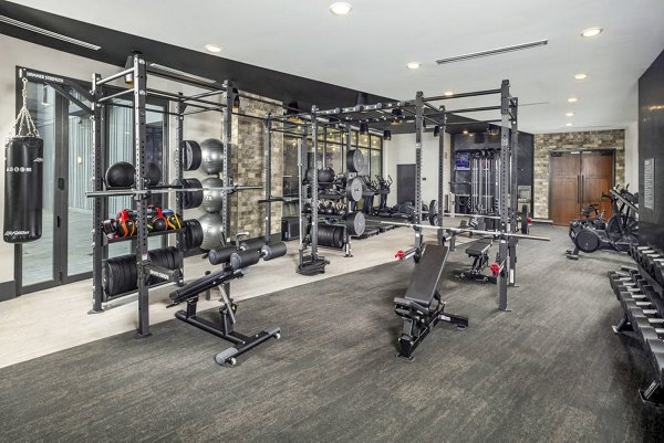 Fully-equipped fitness center at Broadstone Optimist Park Apartments featuring modern gym equipment and dedicated workout spaces