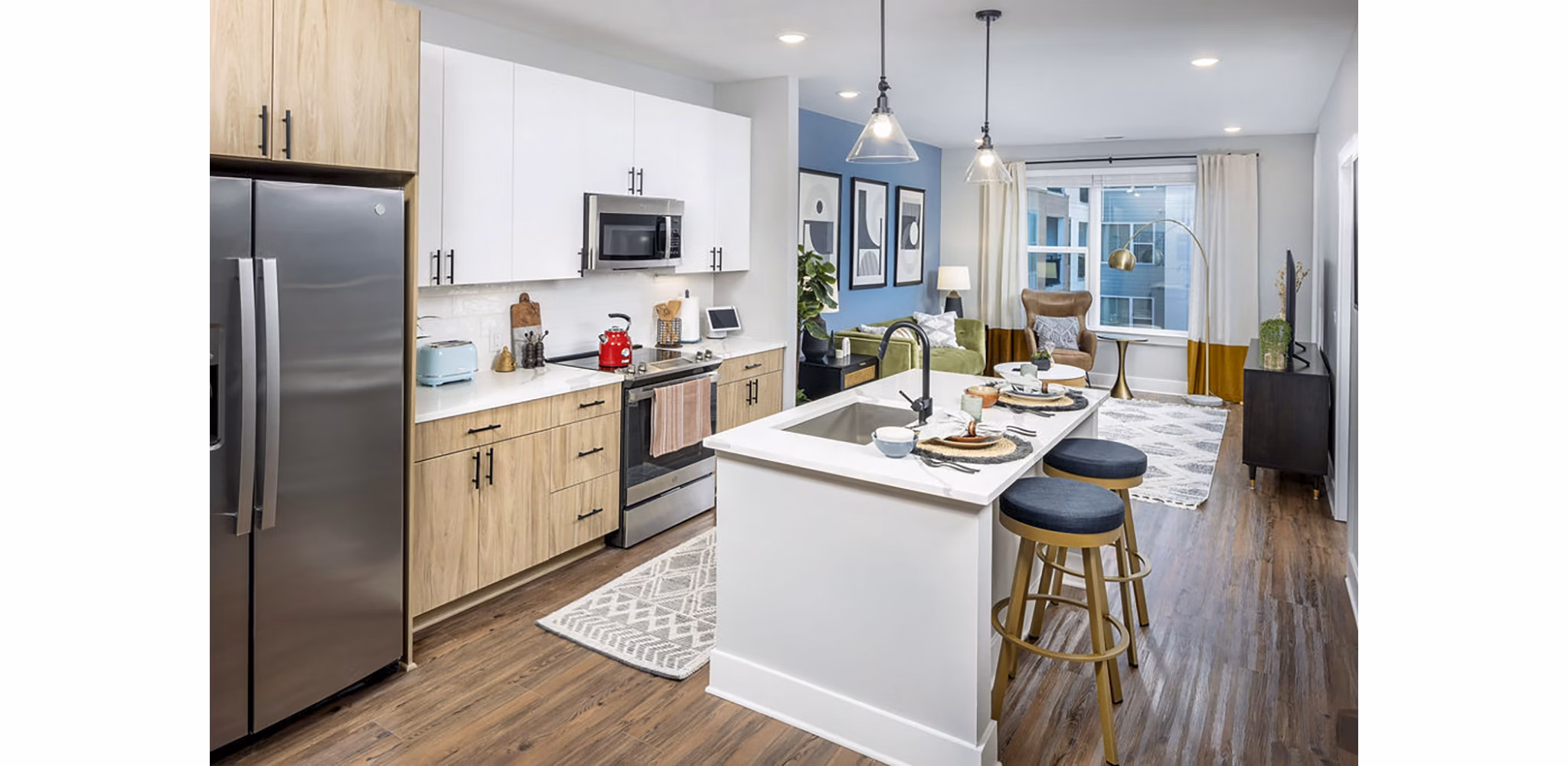 Modern kitchen featuring stainless steel appliances and quartz countertops in Broadstone Optimist Park Apartments