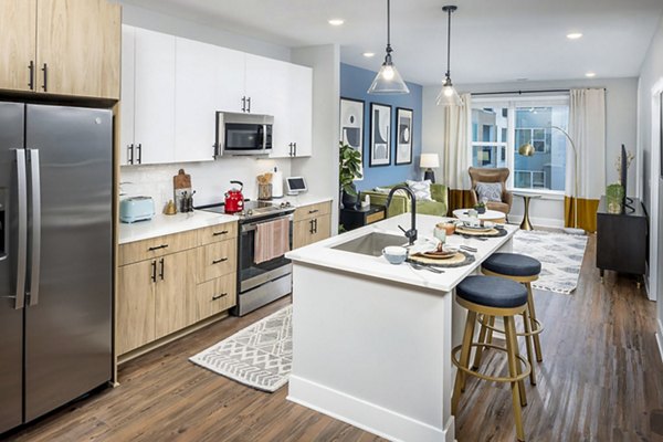 Modern kitchen featuring stainless steel appliances and quartz countertops in Broadstone Optimist Park Apartments