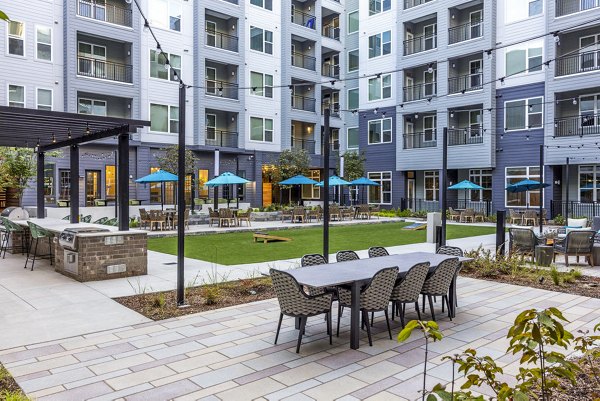 Outdoor grill area and patio at Broadstone Optimist Park Apartments, perfect for community gatherings and relaxation