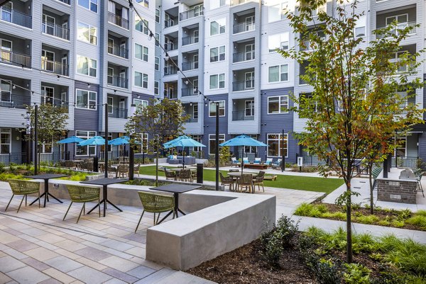 Courtyard patio with outdoor seating at Broadstone Optimist Park Apartments, a luxury Greystar property in a vibrant setting
