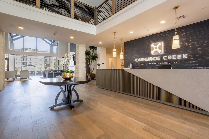 Clubhouse with modern design at Cadence Creek at Towne Lake Apartments, featuring outdoor seating and communal spaces