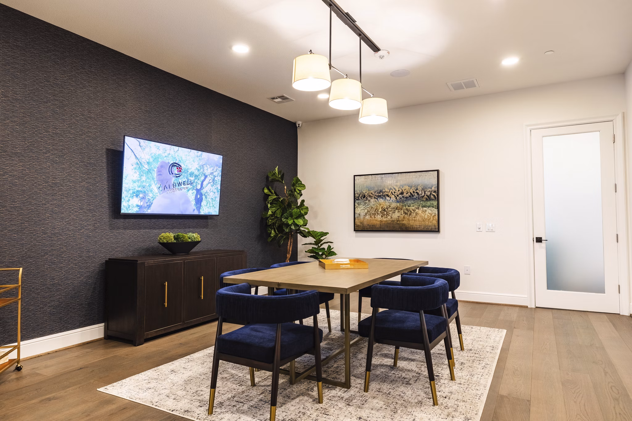Clubhouse meeting facility with modern furnishings at Cadence Creek at Towne Lake Apartments, offering premier spaces for resident gatherings