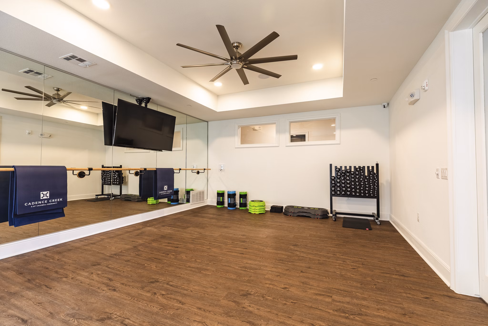 Yoga studio with natural light and sleek flooring at Cadence Creek at Towne Lake Apartments