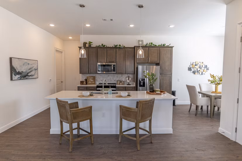 Modern kitchen with stainless steel appliances at Cadence Creek at Towne Lake Apartments