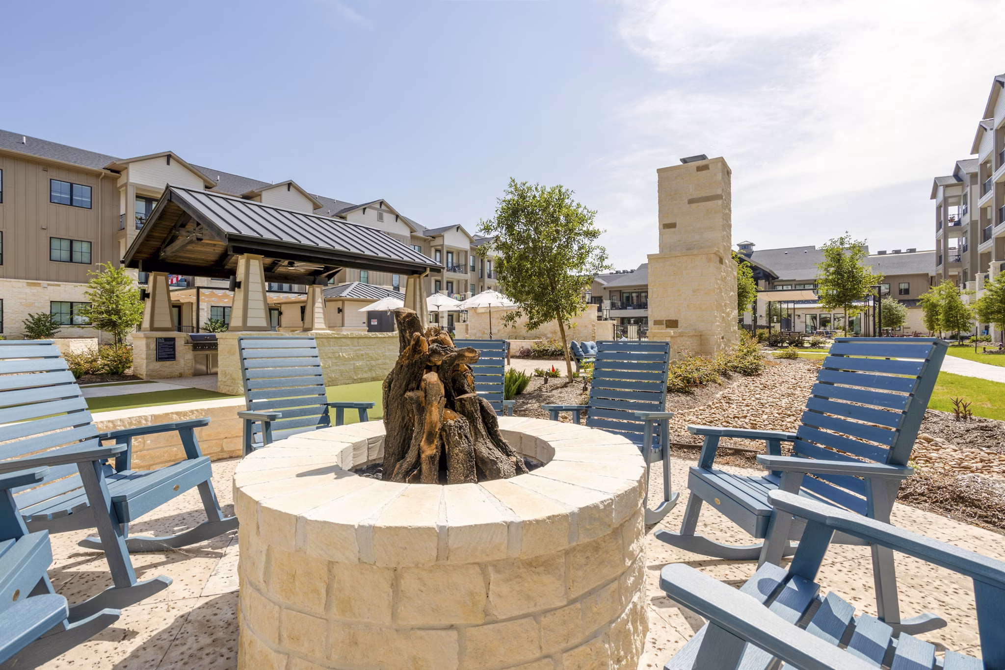 Cozy fire pit on the patio at Cadence Creek at Towne Lake Apartments, perfect for evenings in this luxury living community