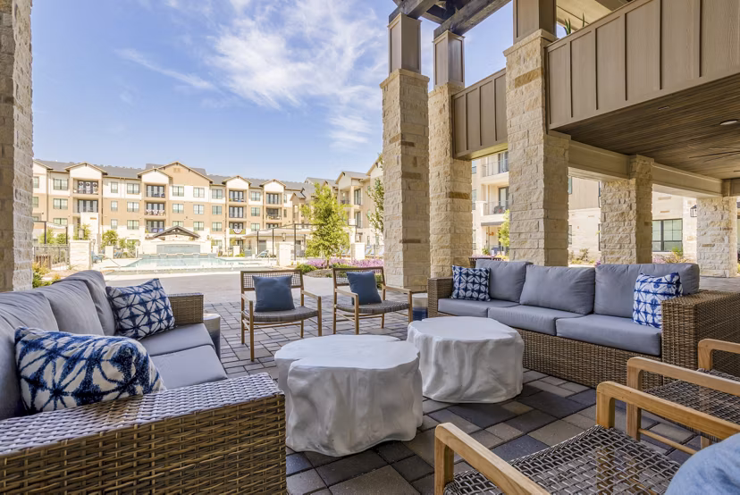 Modern outdoor patio with stylish seating at Cadence Creek at Towne Lake Apartments, perfect for relaxation and entertainment