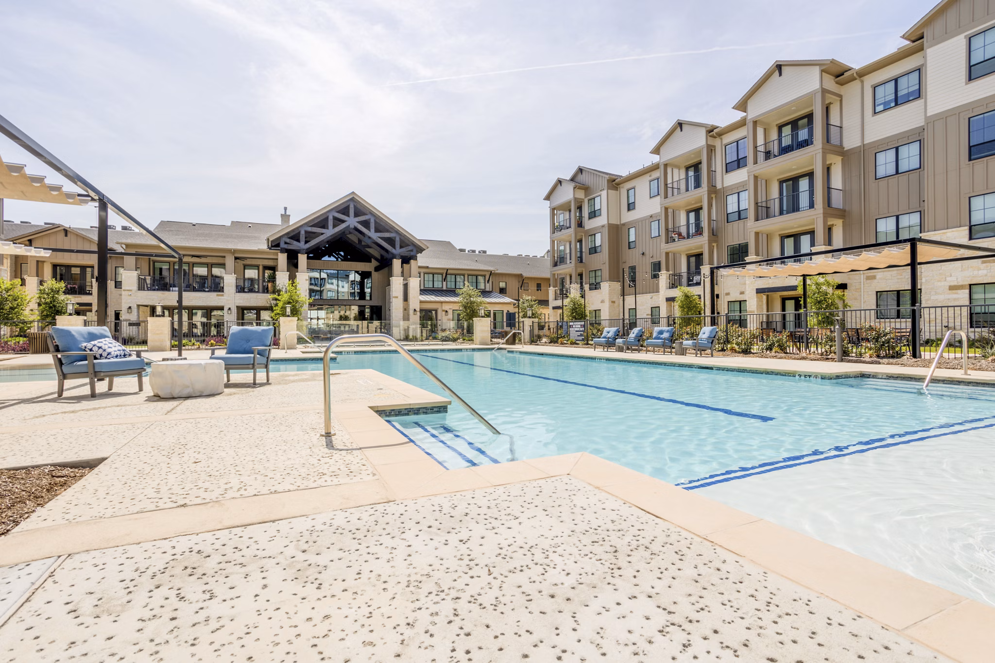 Resort-style pool with sundeck at Cadence Creek at Towne Lake Apartments, offering luxury living amenities
