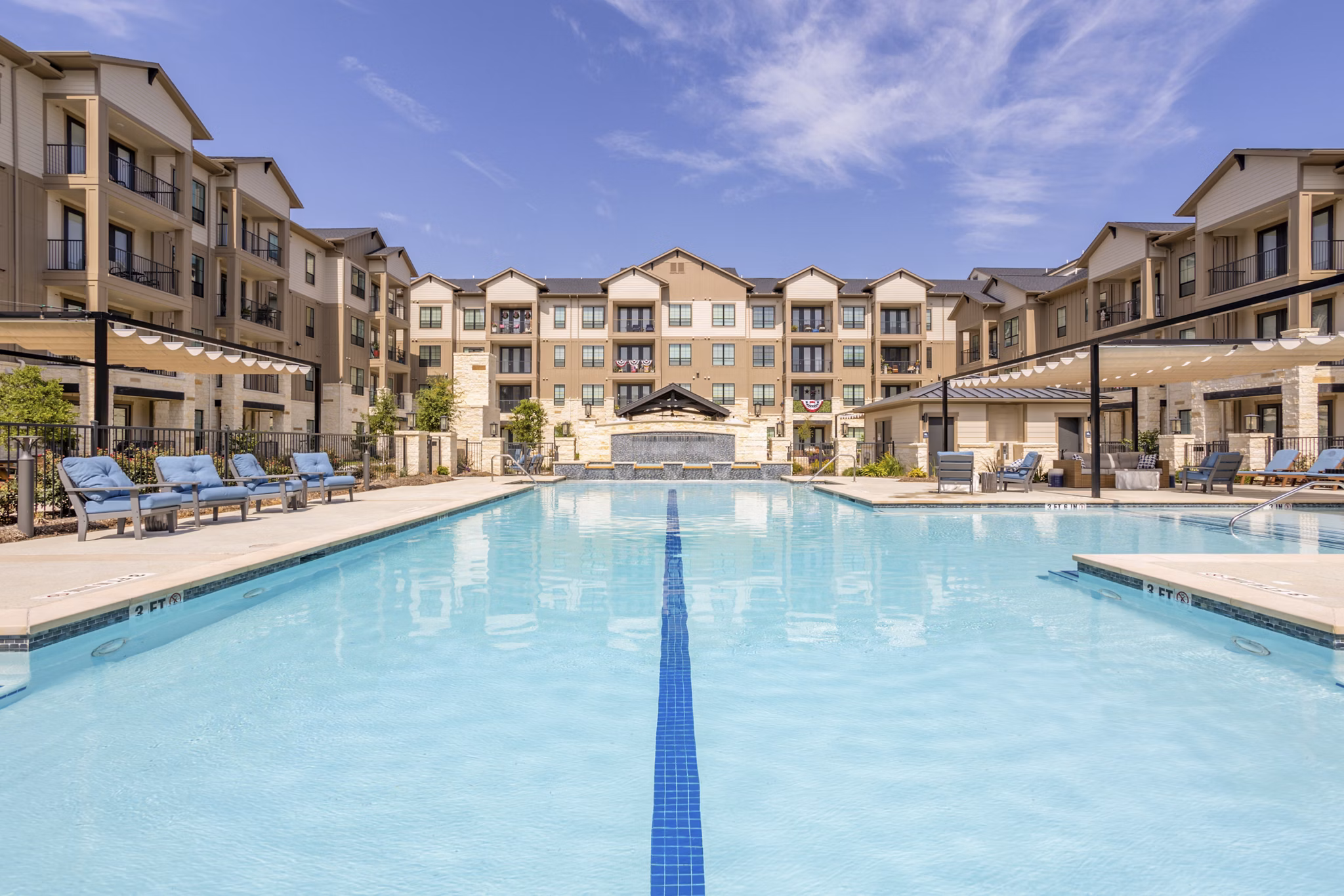 Pool with resort-style seating at Cadence Creek at Towne Lake apartments, a luxury community by Greystar