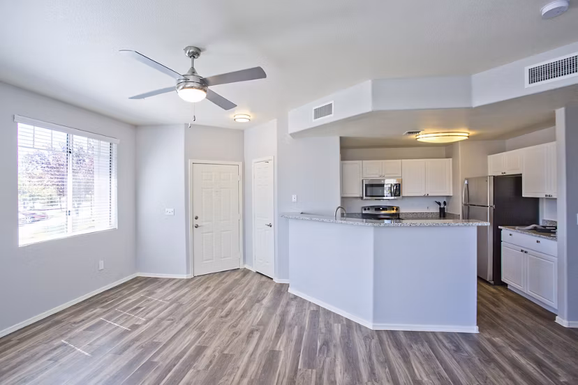 Open-concept living room with modern furnishings and natural light at Legacy at Prescott Lakes Apartments, offering luxury living