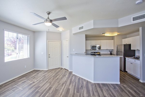 Open-concept living room with modern furnishings and natural light at Legacy at Prescott Lakes Apartments, offering luxury living