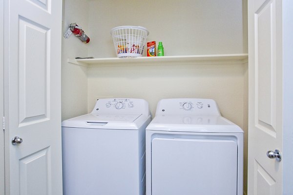 Modern laundry room with energy-efficient washers and dryers at Legacy at Prescott Lakes Apartments