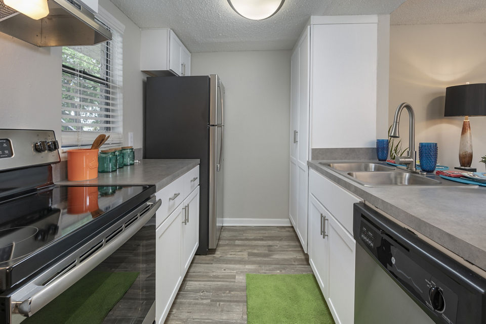 Modern kitchen with stainless steel appliances at Four Lakes at Clearwater Apartments, luxury community