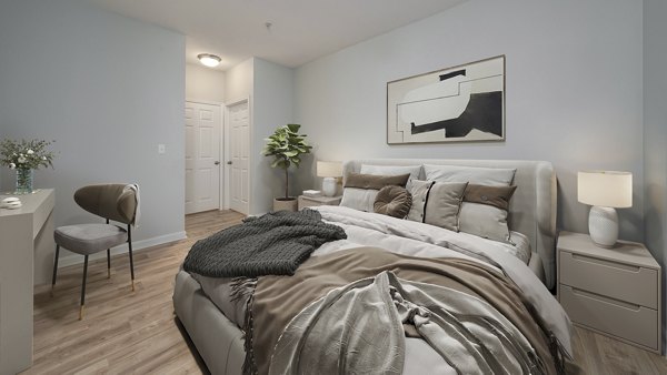 Bedroom showcasing elegant furnishings and neutral palette at Landings at Sweetwater Creek Apartments