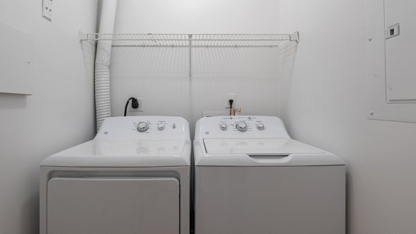 Laundry room with modern appliances at Landings at Sweetwater Creek Apartments