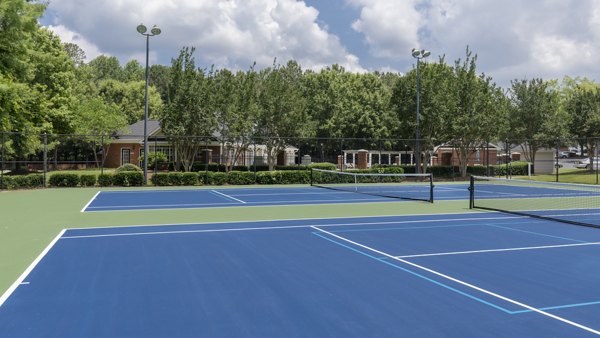 Sport court featuring basketball hoops at Landings at Sweetwater Creek Apartments, offering recreational activities for residents