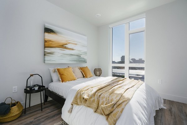 Luxury bedroom with stylish decor at Assembly Apartments featuring calming neutral tones